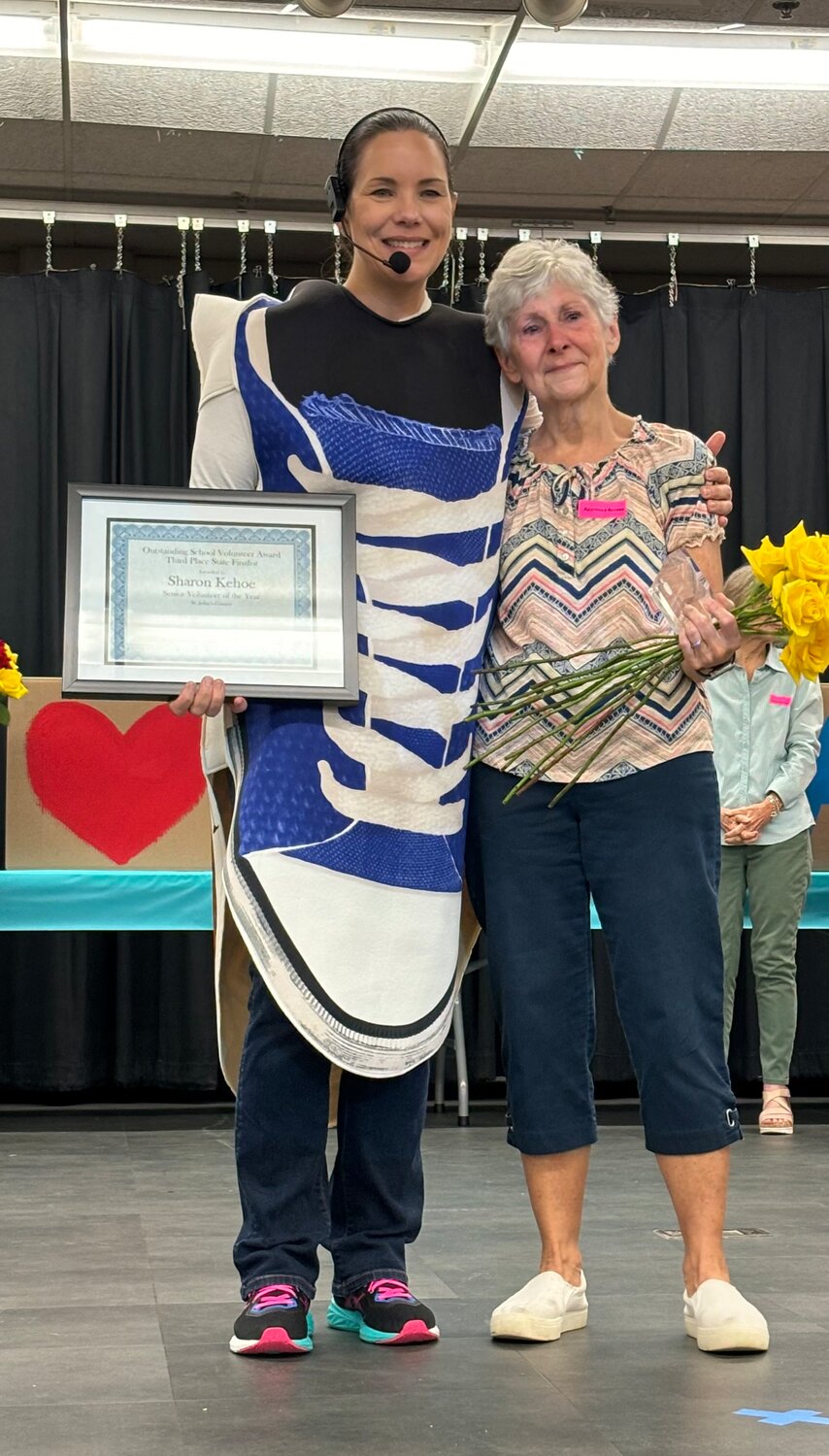 Ocean Palms Elementary School Principal Tiffany Cantwell recognizes Sharon Kehoe for her service and state recognition at the school’s Otter Run pep rally.